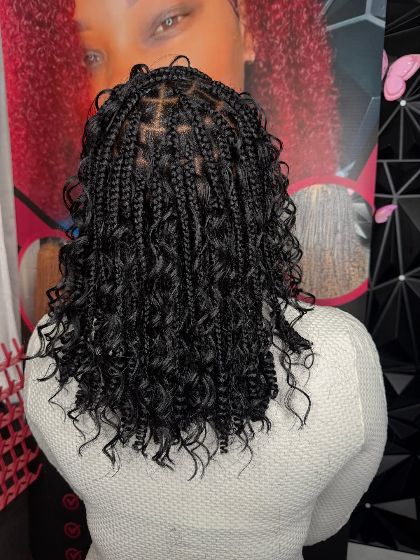 Close-up back view of box braids with curly ends