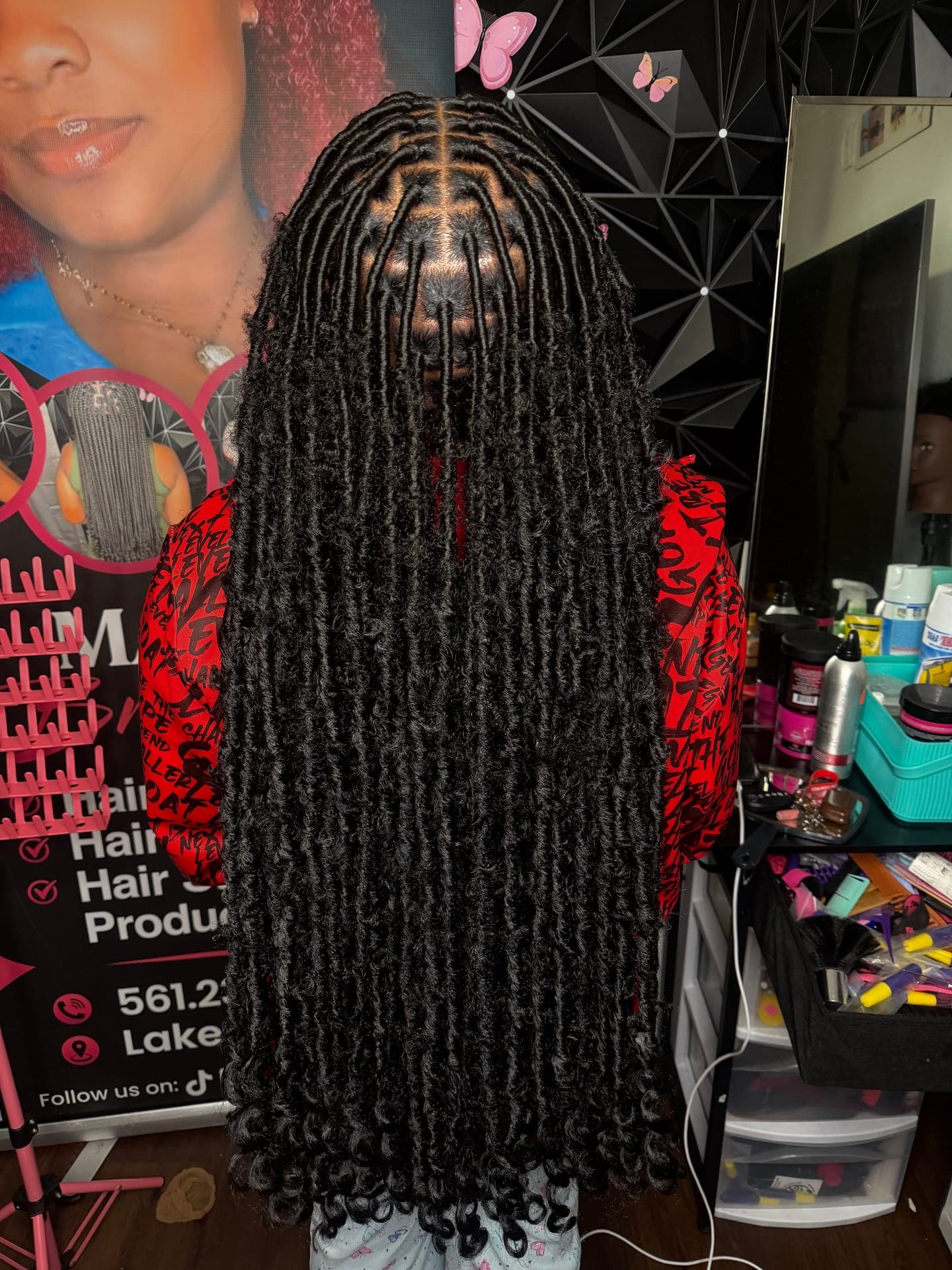 Detailed box braids with curly ends, styled with a red bandana